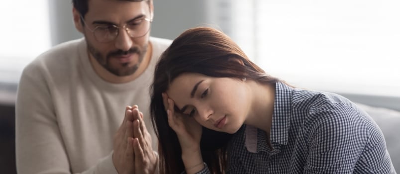 Head Shot Close Up Upset Abused Offended Woman Sitting on Sofa, Ignoring Her Apologizing Husband
