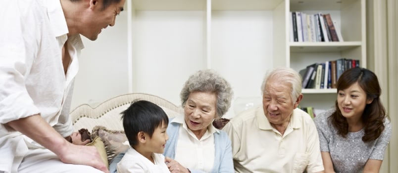 Three-generation Asian Family Talking in Living Room