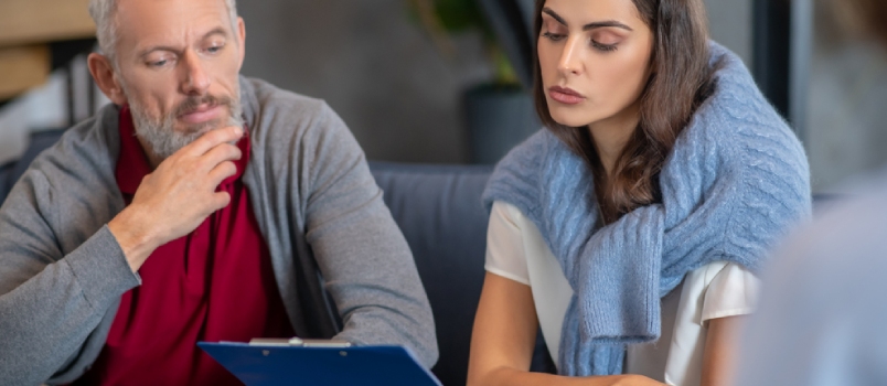 After Therapy. A Man and Woman Checking Their Therapist Report