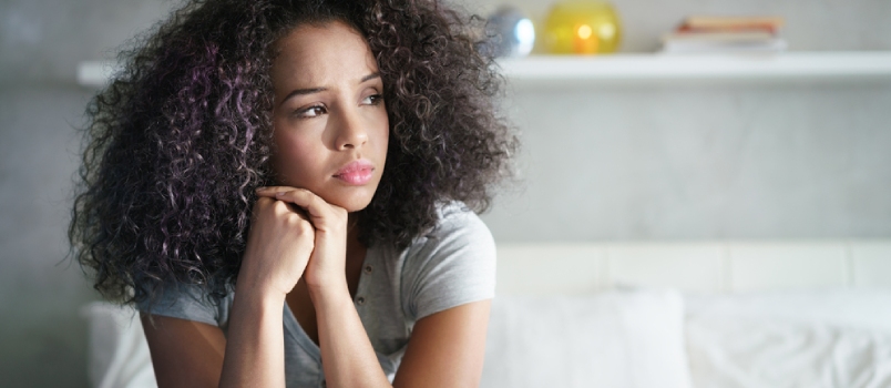 Depressed Hispanic Girl at Home, Looking Away With Sad Expression