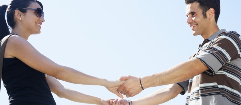 Happy Couple Holding Hands Together and Smiling