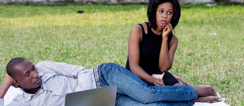 Young Couple Sitting in the Park Sad and Do Not Talk After a Dispute