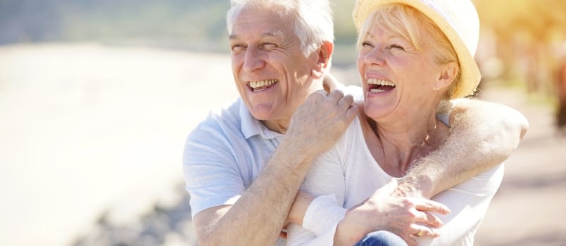 Senior Couple Relaxing by the Sea on Sunny Day