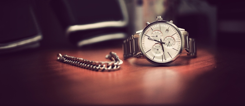 Close Shot a Wrist Watch and Bracelet on the Wooden Table