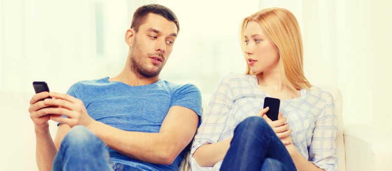 Internet and Happiness Concept - Concentrated Couple With Smartphones at Home
