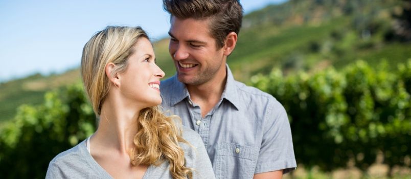 Directly Below Portrait of Happy Couple Against Sky on Sunny Day