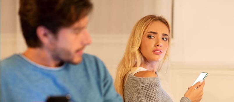 Infidelity husband texting on cellphone