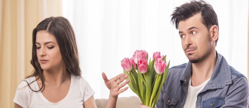 man gifting flowers to woman