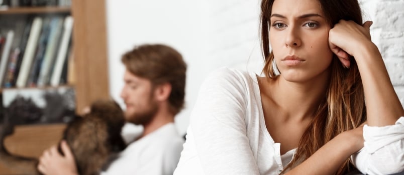 sad couple sitting together at home