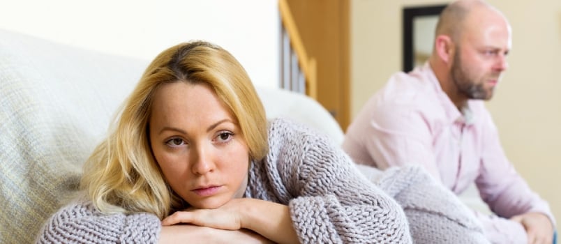 Couple quarrel. Sad guy and wailful girl during quarrel in living room at home couple having problems at home