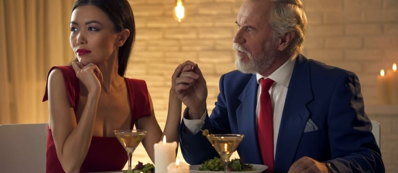 Young Mistress Ignoring Elderly Man During Date