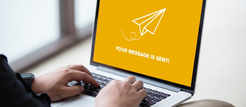 Man working on laptop and sent a message to someone at modern office