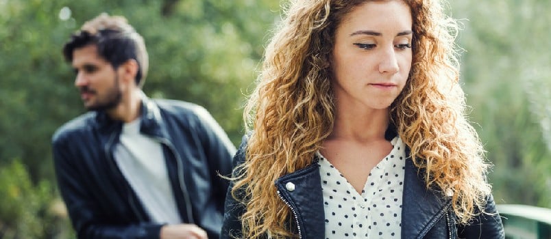 Sad Couple Standing Together at the Park Outside