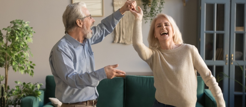 Old Age Couple Dancing Together at Home