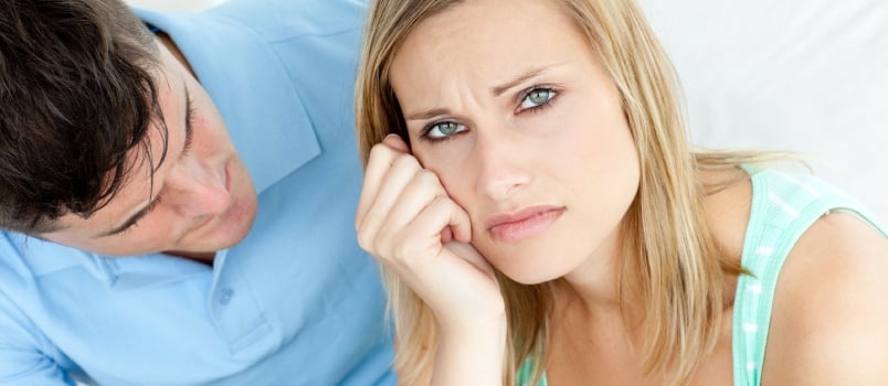 Sad couple having an argue in the living-room at home