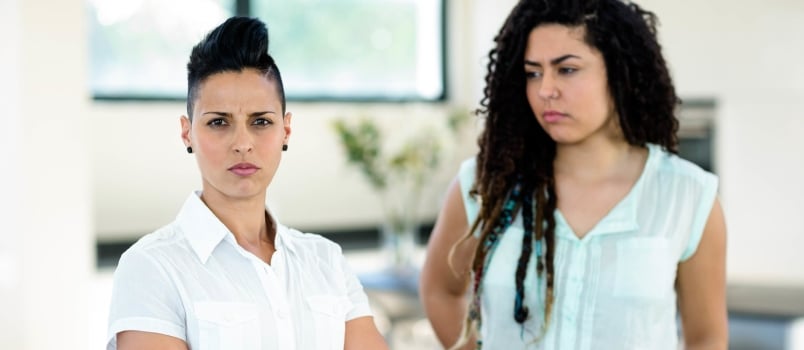 Unhappy Lesbian couple ignoring each other at home