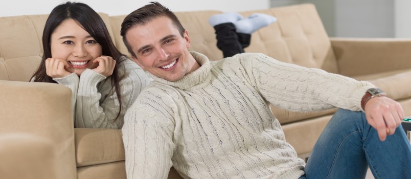 Happy Multiethnic Couple Relaxing at Home