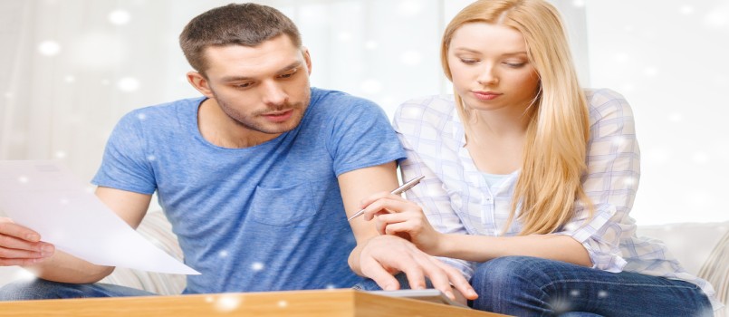 Couple is busy with pen paper and calculator