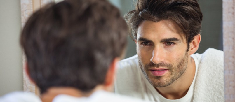 Man looking himself in mirror