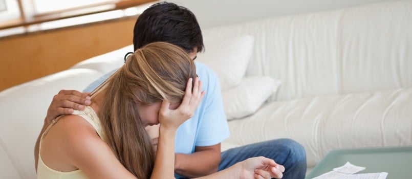 Sad couple sitting on sofa