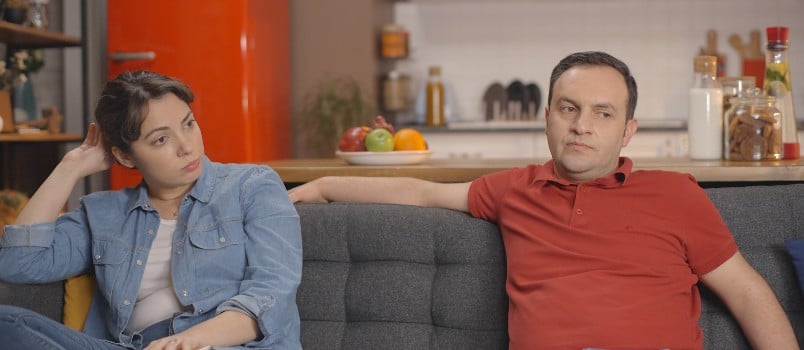 cheating young couple setting on sofa