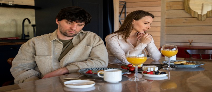 stressed young couple sites separately