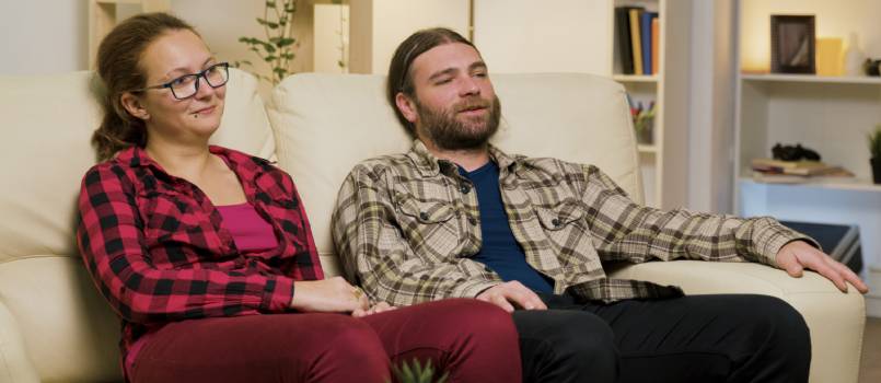 Young couple sitting in living room