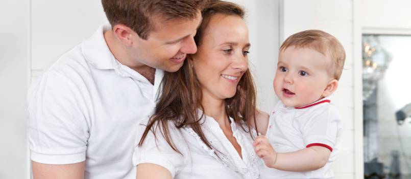 Mother and father holding their smiling child