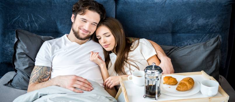 Couple having having breakfast in bed