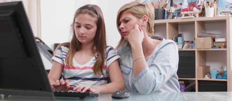 Mother daughter working on computer