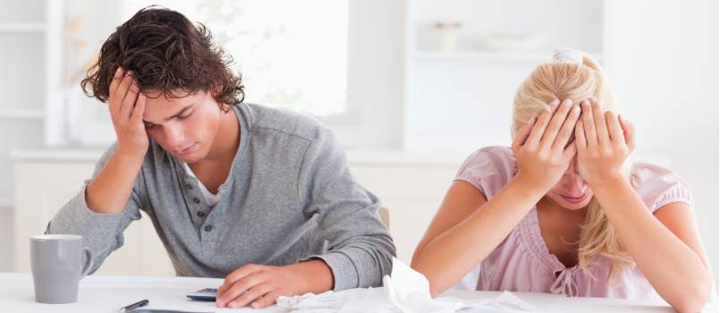 Sad couple doing accounting