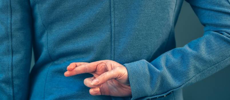 Women has crossed her finger