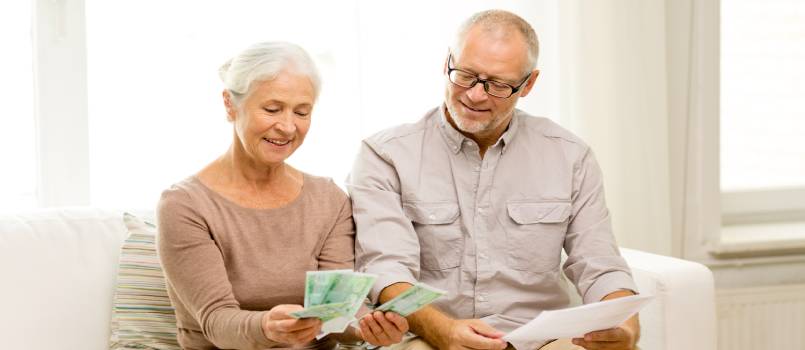 Senior couple with money and calculator