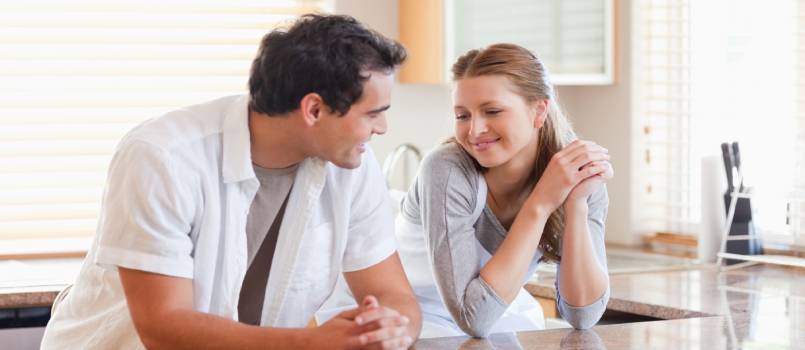 Couple talking in kitchen