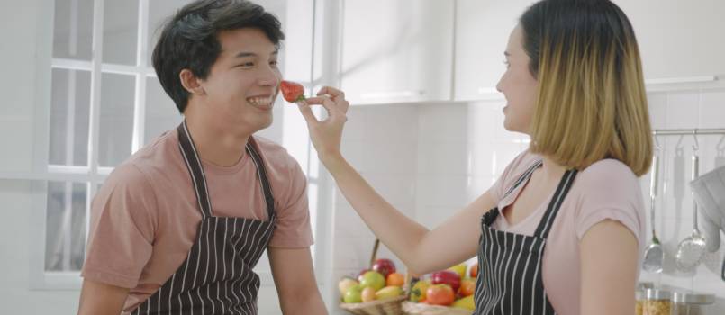 Couple working in kitchen