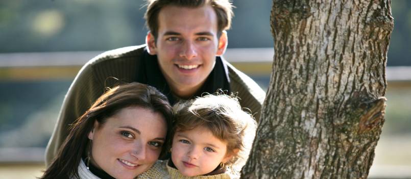 Happy couple with their kid in park