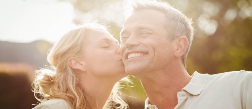 Wife kissing husband on checks