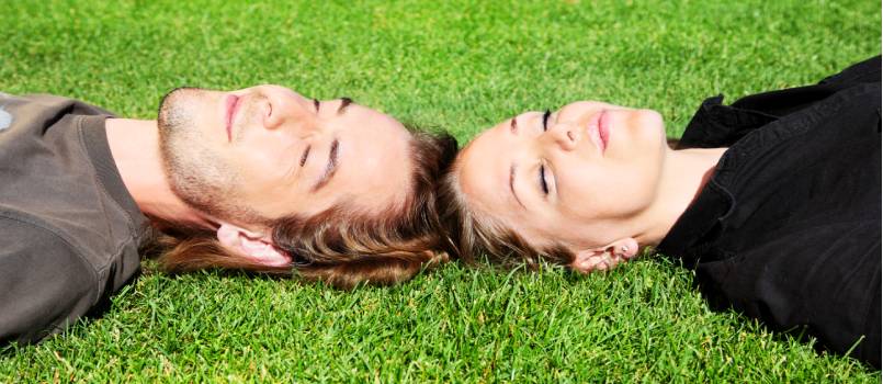 Happy couple laying on grass