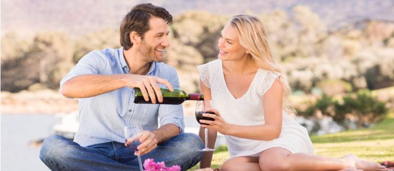 Cute couple on a date pouring wine