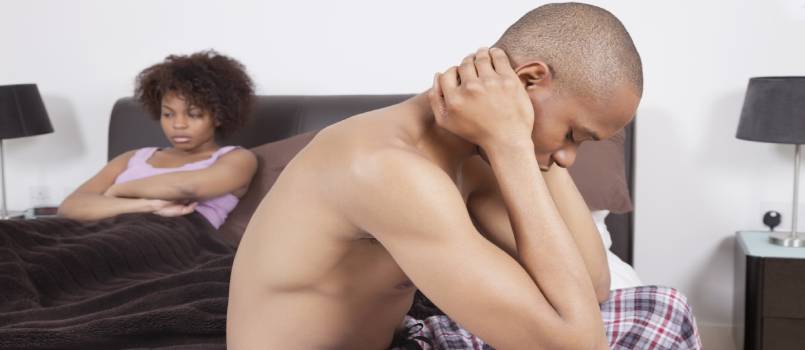 American couple ignoring each other in bedroom