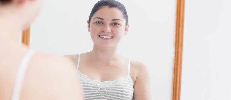 Women looking at self in mirror