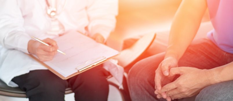 Male Patients With Psychologist Holding Client Chart In Psychotherapy Session