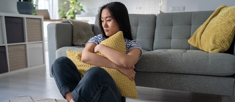 Sad girl sitting on the floor
