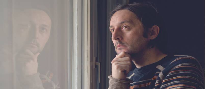 Sad man by the window