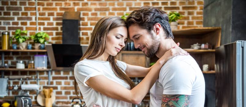 Couple working in kitchen
