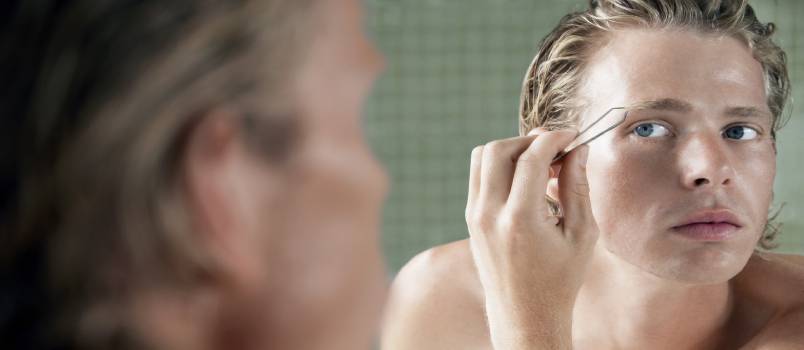 Man plucking eyebrow