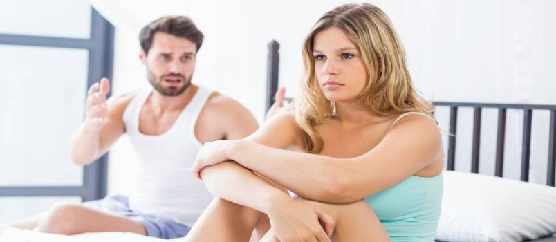 Young couple having argument in bed