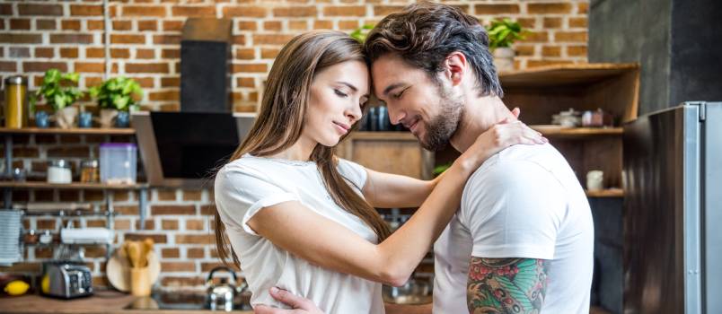 Couple hugging in kitchen
