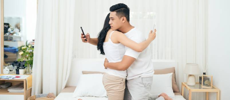 Young couple in bedroom cheating each other