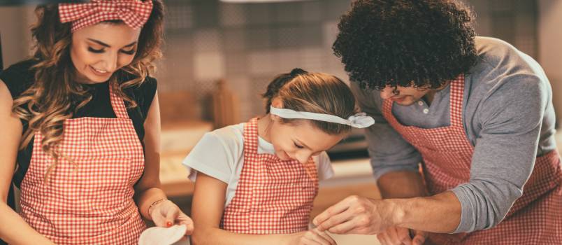 Daughter helping parents in kitchen